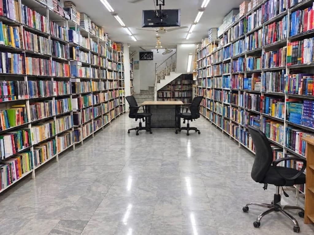 Allied Book Co. aisle lined with bookshelves leading to the upper level